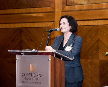 Female speaker this morning, standing at podium. Event photography