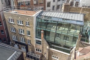 Ariel photograph of building with large glass wall.